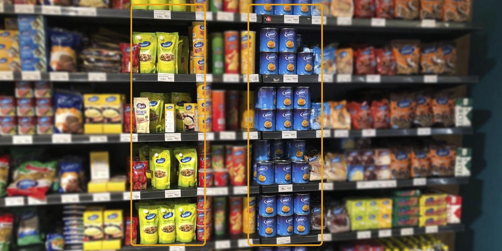 Góndola de supermercado con productos alimenticios organizados por marca. Algunos envases están destacados con rectángulos amarillos y azules, mostrando agrupación visual estratégica (brand blocking) para facilitar la identificación y reforzar la presencia de marca.
